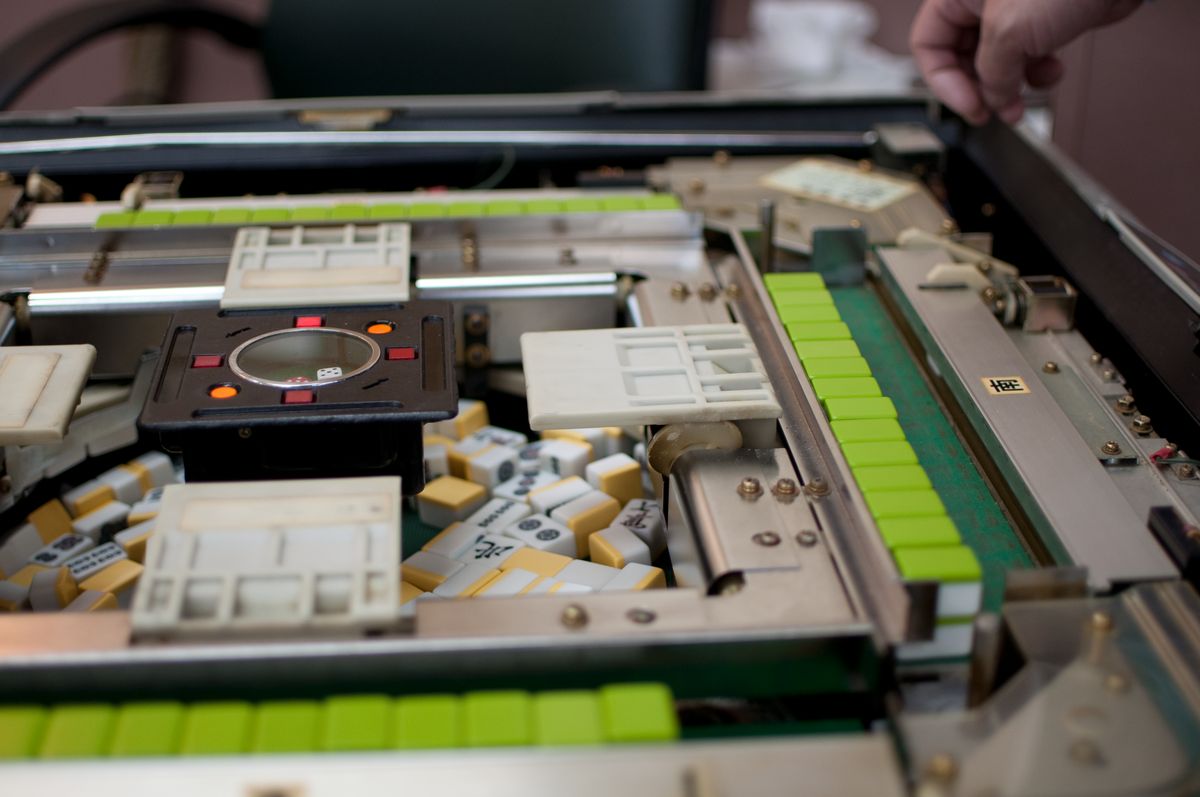 An automatic mahjong table opened to show the motor and tile-lifting parts, as found in an automatic mahjong table Malaysia shops sell