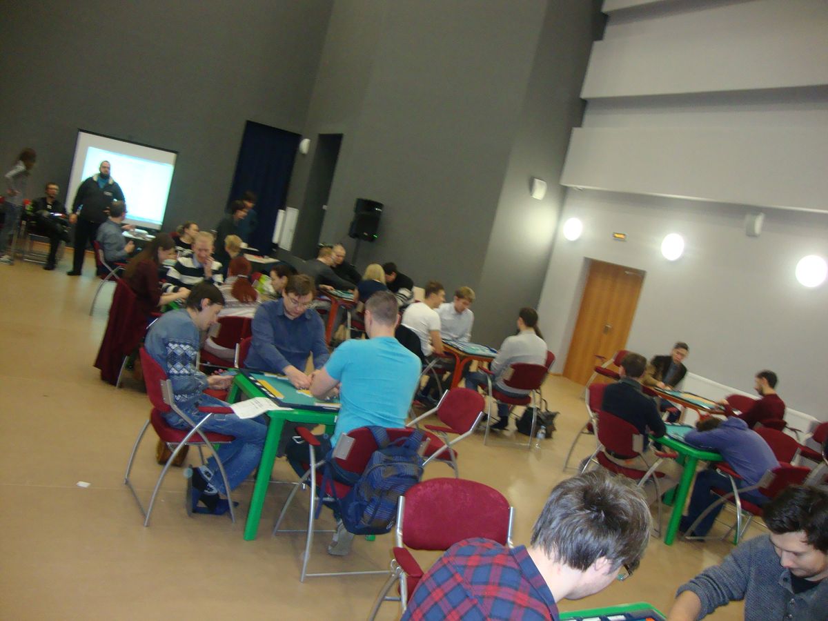 Players at rows of tables in a mahjong tournament hall, the kind of event a mahjong competition Malaysia player might travel to
